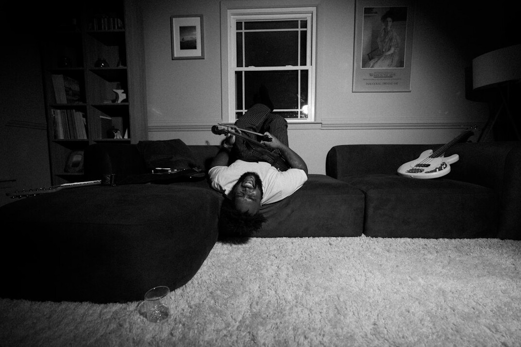 musician playing guitar at home
